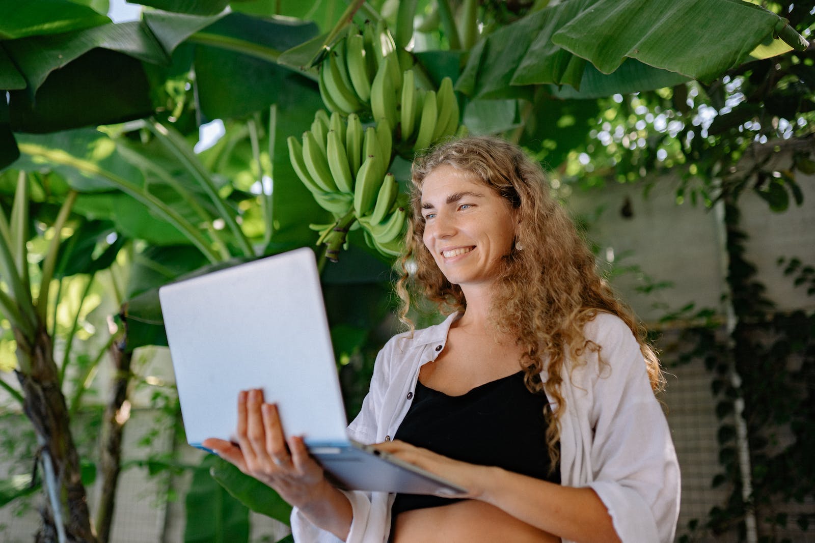 Woman in White Blazer Holding White Tablet Computer